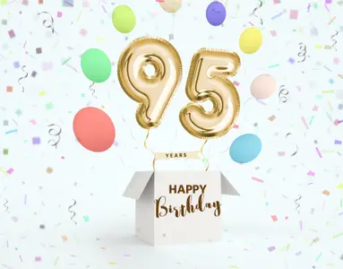 Goldene 95 als Luftballons steigt aus weißer Box, Happy Birthday als Schriftzug, runde, bunte Ballons steigen auf